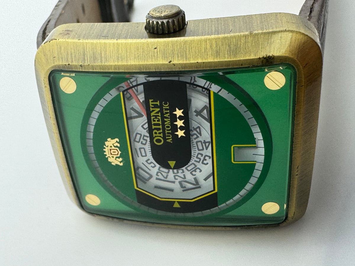 Orient Automatic – green dial, rectangular case – disc display – 35.8 × 40.7 mm