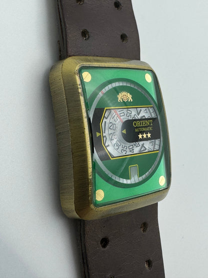 Orient Automatic – green dial, rectangular case – disc display – 35.8 × 40.7 mm